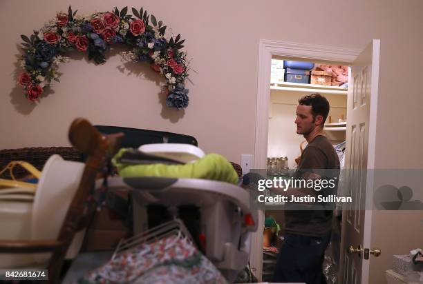 Andrew Teague looks through items as he cleans out their flooded home on September 4, 2017 in Katy, Texas. Over a week after Hurricane Harvey hit...