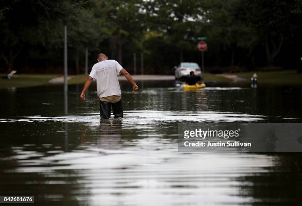 Man walks through a flooded street on September 4, 2017 in Katy, Texas. Over a week after Hurricane Harvey hit Southern Texas, residents are...