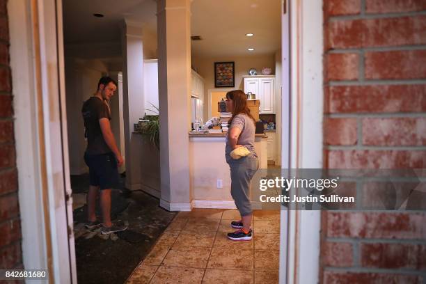 Melissa Teague talks with her son Andrew Teague as they clean out their flooded home on September 4, 2017 in Katy, Texas. Over a week after Hurricane...