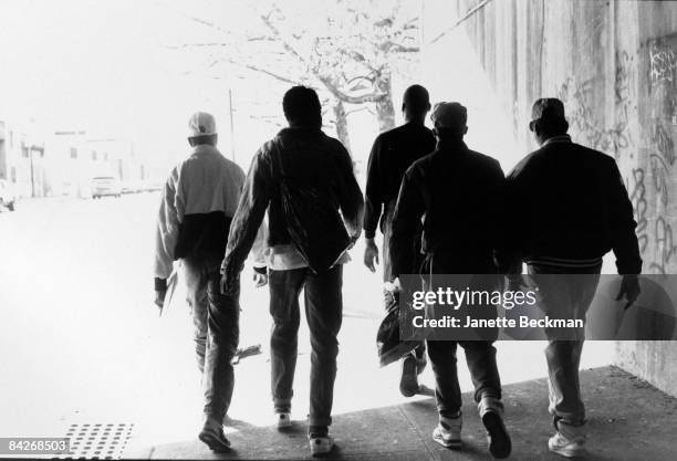 Unidentified members of BDP or Boogie Down Productions, the pioneering hiphop music group, walk along a street in the Bronx, 1987. New York.