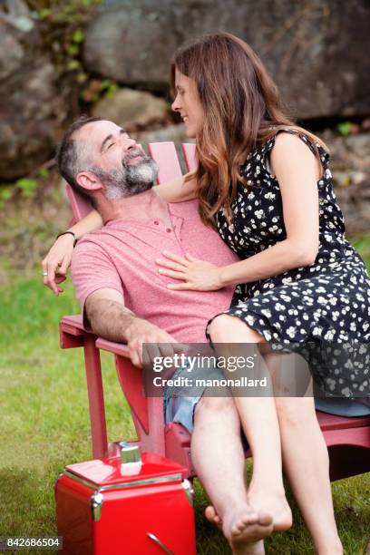 portrait of a couple having fun together on a land by the river - age contrast stock pictures, royalty-free photos & images