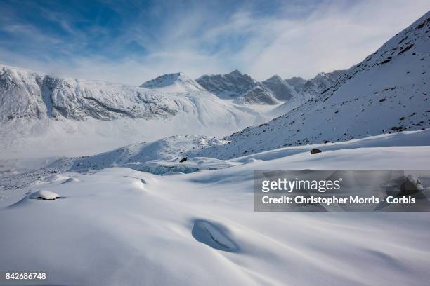 The Turner Glacier and Mountains surround the frozen landscape of Akshayuk Pass, in Auyuittuq National Park on April 10, 2017 on Baffin Island,...