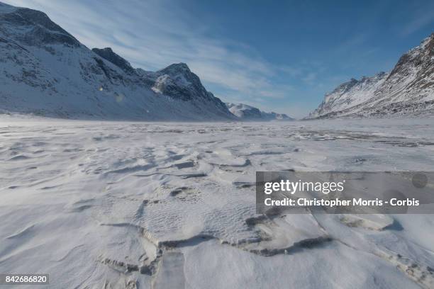 Mountains surround the frozen Weasel River through Akshayuk Pass, in Auyuittuq National Park on April 16, 2017 on Baffin Island, Canada.