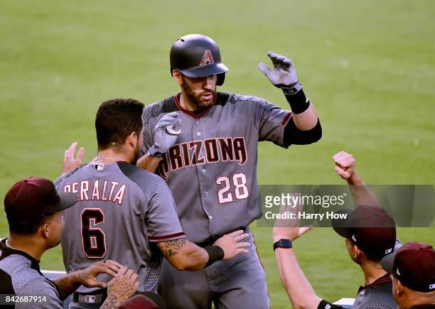 Martinez of the Arizona Diamondbacks celebrates his second homerun of the game in the dugout to take 3-0 lead during the seventh inning against the...