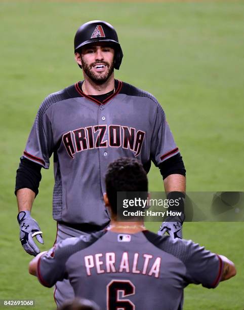 Martinez of the Arizona Diamondbacks reacts as he returns to the dugout after his fourth homerun of the game, to take a 13-0 lead over the Los...