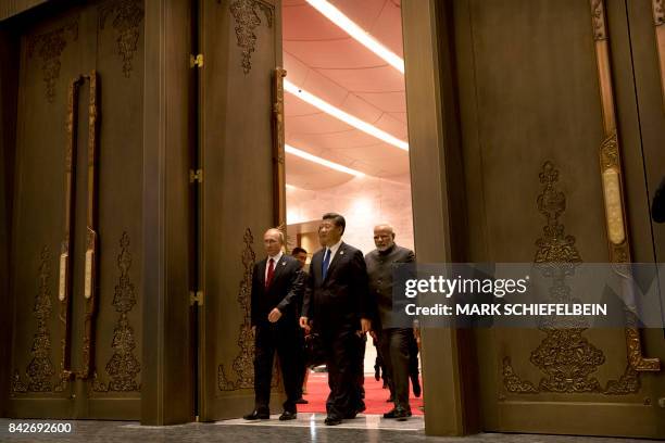 Russian President Vladimir Putin, Chinese President Xi Jinping and Indian Prime Minister Narendra Modi arrive for the Dialogue of Emerging Market and...