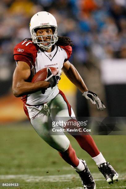 Wide receiver Larry Fitzgerald of the Arizona Cardinals runs the ball against the Carolina Panthers during the NFC Divisional Playoff Game on January...