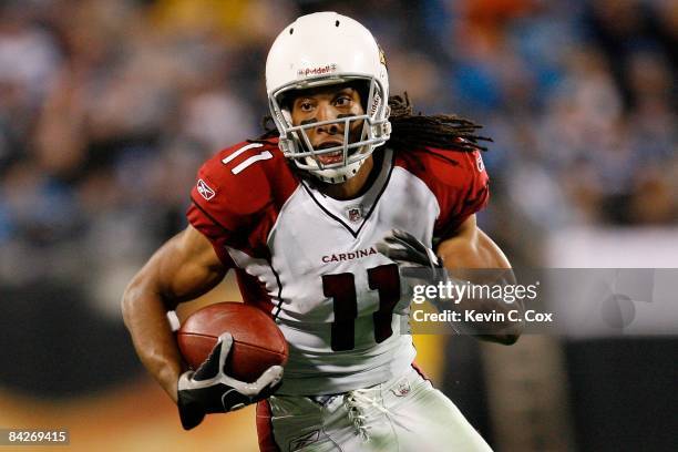 Wide receiver Larry Fitzgerald of the Arizona Cardinals runs the ball against the Carolina Panthers during the NFC Divisional Playoff Game on January...