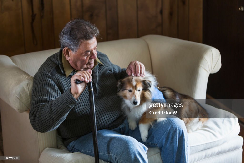 Senior man sitting with his therapy dog