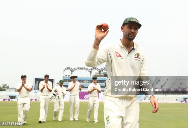 Nathan Lyon of Australia holds up the ball after he took seven wickets in the first innings during day two of the Second Test match between...