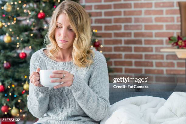 sitting alone - holiday sadness stock pictures, royalty-free photos & images