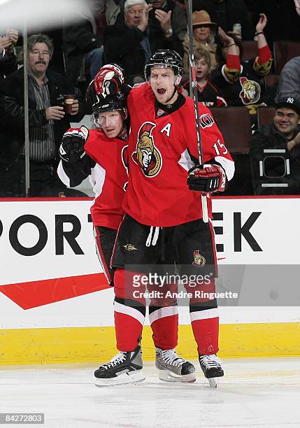Dany Heatley of the Ottawa Senators celebrates his first-period goal against the Carolina Hurricanes with teammate Daniel Alfredsson at Scotiabank...