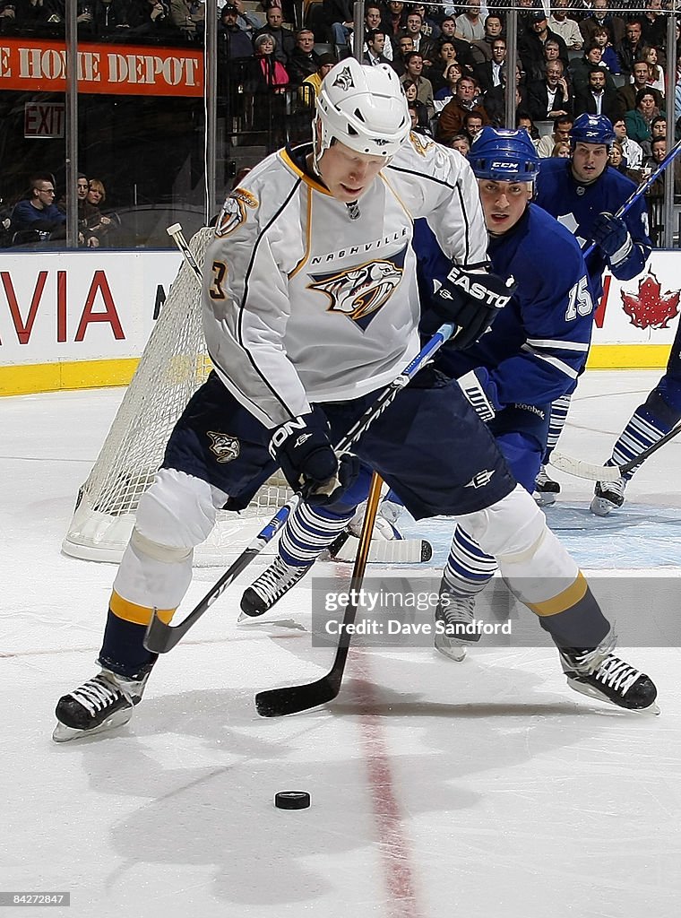 Toronto Predators Tomas Kaberle of the Toronto Maple Leafs defends against Wade Belak ...