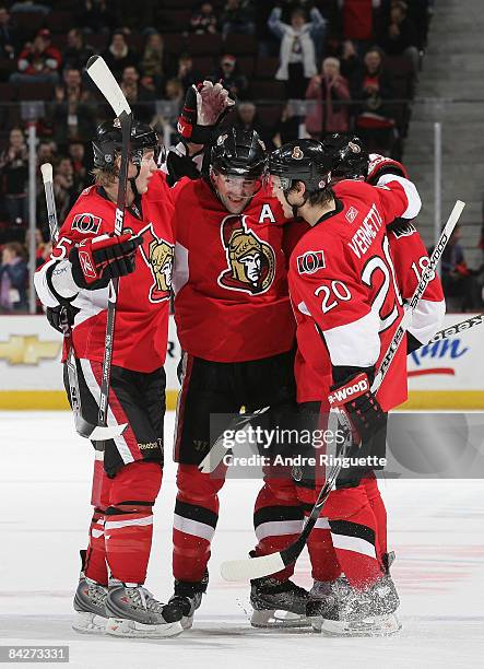 Chris Phillips of the Ottawa Senators celebrates his third-period goal against the Carolina Hurricanes with teammates Brian Lee and Antoine Vermette...