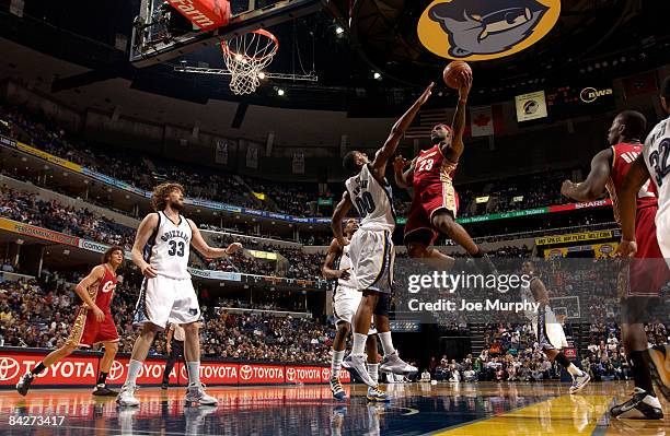 LeBron James of the Cleveland Cavaliers shoots around Darrell Arthur of the Memphis Grizzlies on January 13, 2009 at FedExForum in Memphis,...