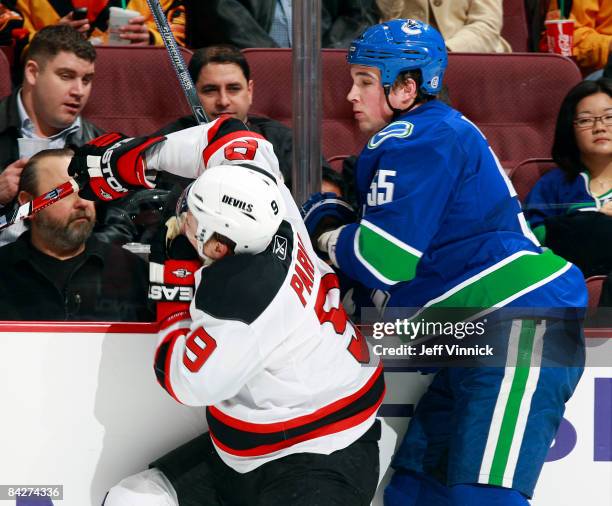 Shane O'Brien of the Vancouver Canucks high sticks Zach Parise of the New Jersey Devils during their game at General Motors Place on January 13, 2009...