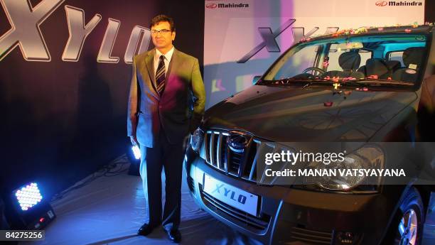 Chief of operations in the automotive sector of Mahindra and Mahindra, Rajesh Jejurikar poses with the newly unveiled " Xylo " car in New Delhi on...