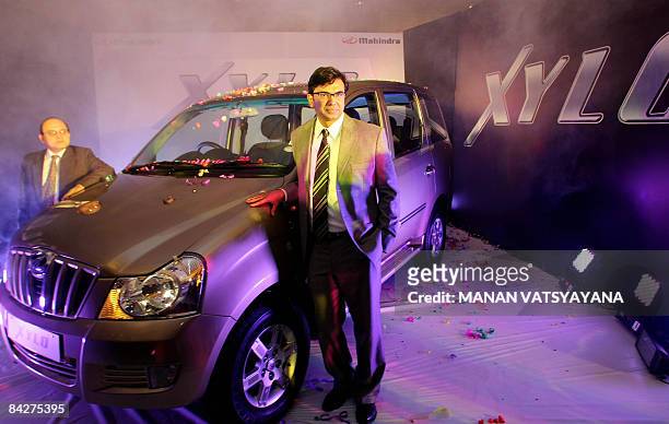 Chief of operations in the automotive sector of Mahindra and Mahindra, Rajesh Jejurikar poses with the newly unveiled " Xylo " car in New Delhi on...