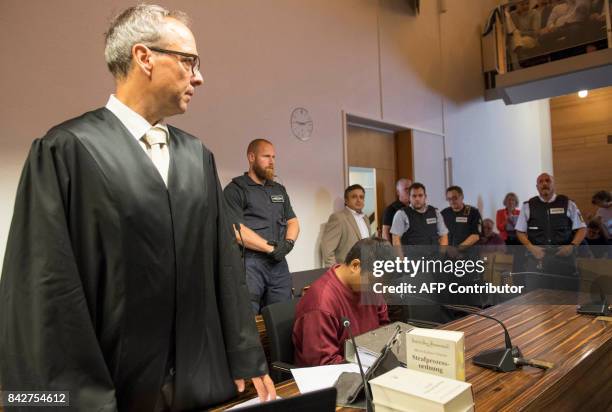 Husseen K , who is accused of raping and killing a young woman in October 2016, and his lawyer Sebastian Glathe wait at the court room at the...