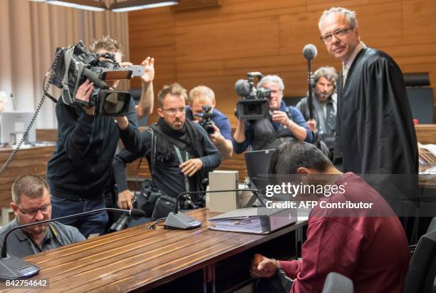 Husseen K , who is accused of raping and killing a young woman in October 2016, and his lawyer Sebastian Glathe wait at the court room at the...