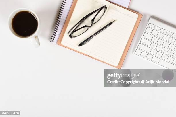 flat lay office desk blank page notebook with coffee mug, eyeglasses, pen, computer keyboard copy space - office work flat lay stock pictures, royalty-free photos & images