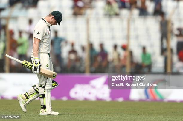 Steve Smith of Australia walks off after he was bowled by Taijul Islam of Bangladesh aduring day two of the Second Test match between Bangladesh and...