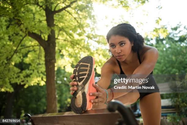 young fitness woman doing stretching exercise - runner warming up stock pictures, royalty-free photos & images