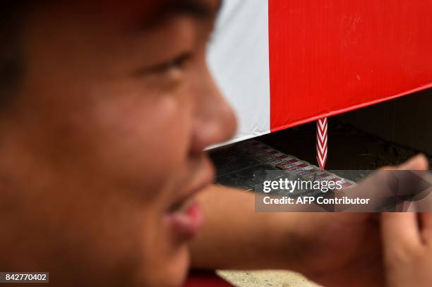 Distance marker is seen along a track as Chinese construction personnel work to relocate the main hall of the 135-year old Yufo Temple, also known as...