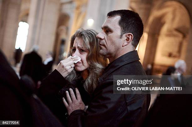 Woman cries at the courthouse in Paris on January 14 after a French court cleared six health officials charged over the deaths of 117 children who...