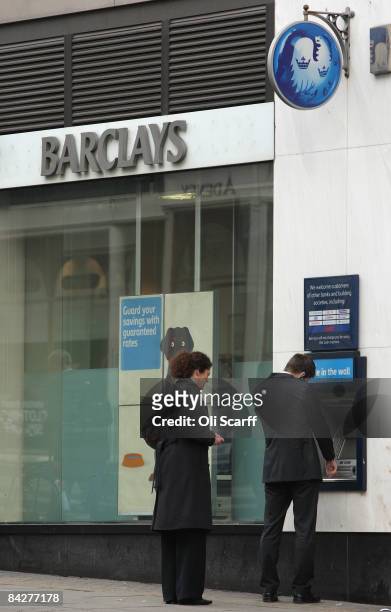Members of the public use a cash machine at a branch of Barclays bank on January 14, 2009 in London, England. Barclays bank has announced it is to...