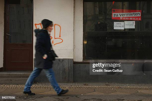 Woman walks past a 'For Rent' sign in a an empty store window on January 14, 2009 in Berlin, Germany. According to economic data released today the...