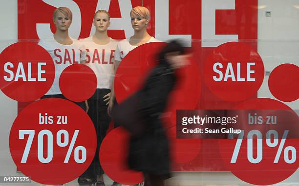 People walk past sale signs in a department store window on January 14, 2009 in Berlin, Germany. According to economic data released today the German...