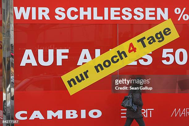 People walk past a clothing store announcing sales and the store's imminent closure on January 14, 2009 in Berlin, Germany. According to economic...