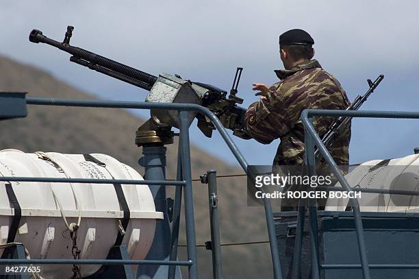 Sailor mans a machine gun on the Russian missile cruiser, "Peter the Great", anchored in Table Bay Harbour, in Cape Town, on January 14, 2009. This...