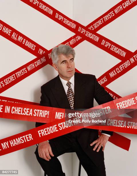 English publicist Max Clifford with some of the more memorable headlines generated by his activities, circa 2000.