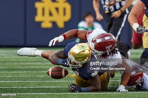 Notre Dame Fighting Irish running back Tony Jones Jr. Fumbles the football after being tackled by Temple Owls defensive lineman Sharif Finch during...