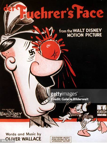 Donald Duck throws a tomato at Adolf Hitler on the sheet music for the title song of the Walt Disney film 'Der Fuehrer's Face', 1942.
