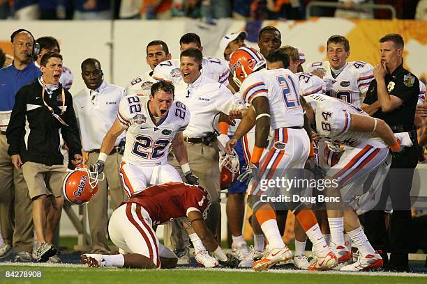 Cade Holliday and Major Wright of the Florida Gators taunt Manuel Johnson of the Oklahoma Sooners after Johnson couldn't hold on to the ball after...