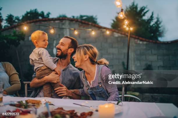 birthday boy and his parents - family in garden imagens e fotografias de stock
