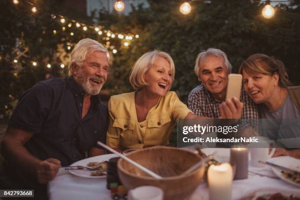 capturing memories from dinner party - retirement party stock pictures, royalty-free photos & images