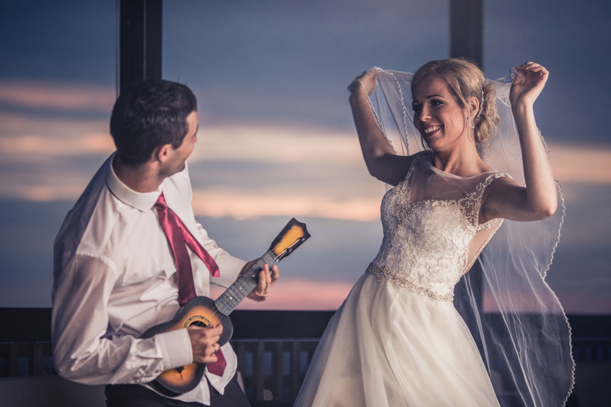 Happy newlywed couple celebrating and having fun on their wedding day. Happy newlywed couple celebrating and having fun on their wedding day.