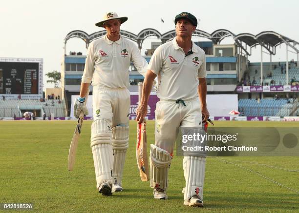 Peter Handscomb and David Warner of Australia walk off at the end of play during day two of the Second Test match between Bangladesh and Australia at...