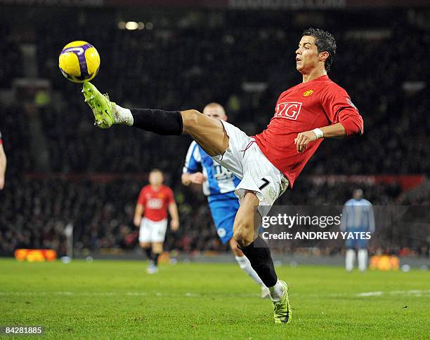 Manchester United's Portuguese midfielder Cristiano Ronaldo controls the ball during the English Premiership football match against Wigan at Old...