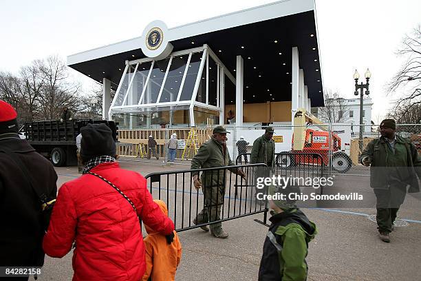 National Park Service workers set out barricades in front of the enclosed and bullet-resistant review stand where President-elect Barack Obama, his...