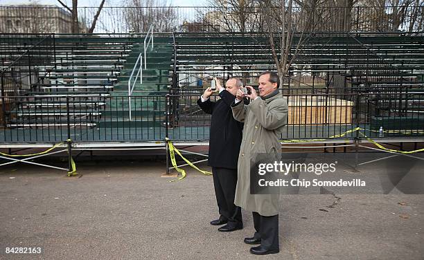 People use their cameras and cell phones to take photographs of the inaugural parade review stand on Pennsylvania Avenue between Lafayette Park and...