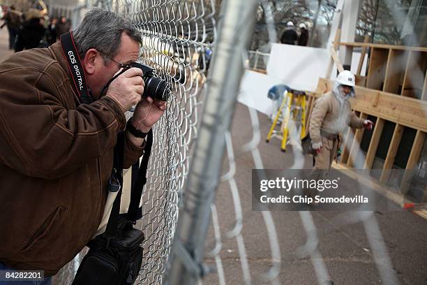 People use their cameras and cell phones to take photographs of the inaugural parade review stand on Pennsylvania Avenue between Lafayette Park and...