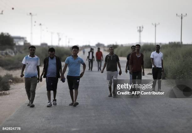 Detained African illegal immigrants stroll outside the Holot detention center in Israel's southern Negev desert, near the Egyptian border on...