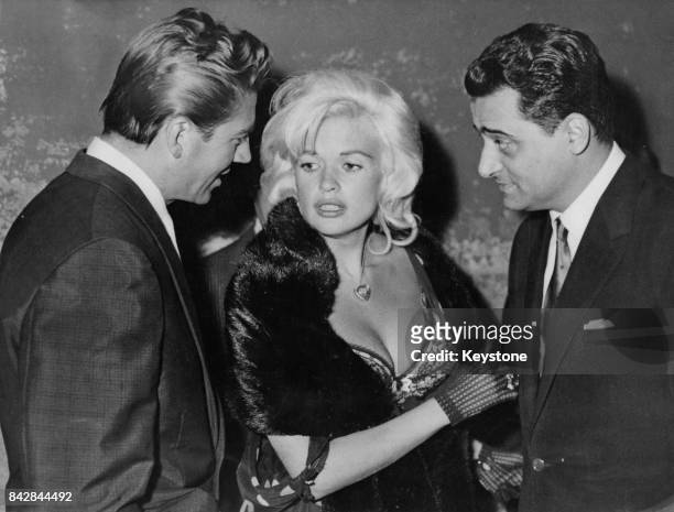 American actress Jayne Mansfield with her husband Mickey Hargitay and Italian film executive Enrico Bomba in Rome, Italy, July 1962. Mansfield and...