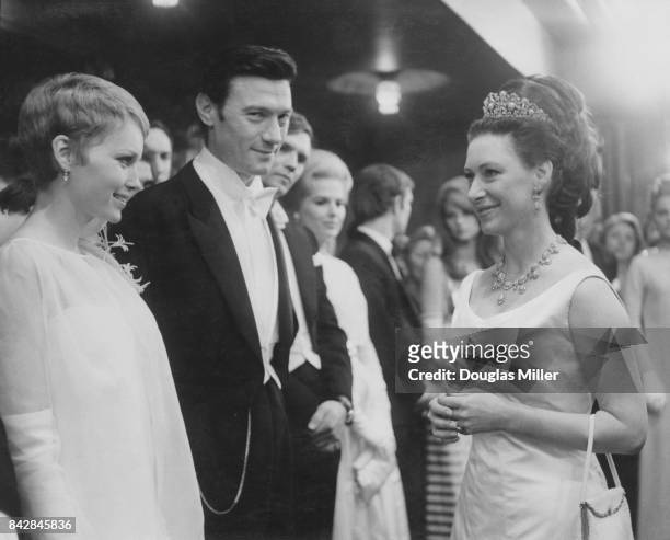 Princess Margaret meets Lithuanian-born actor Laurence Harvey and actress Mia Farrow at the Royal Film Performance of the film 'The Taming of the...