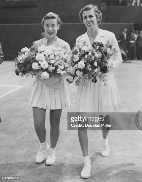 American tennis players Maureen Connolly and Doris Hart walk onto the court for the final of the Women's Singles at Wimbledon, London, 4th July 1953.